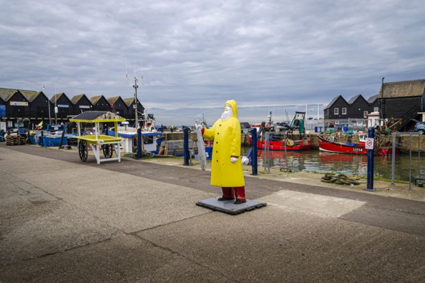 Whitstable, Kent, UK, February 2021 - Fisherman statue in the harbour at Whitstable, Kent, UK