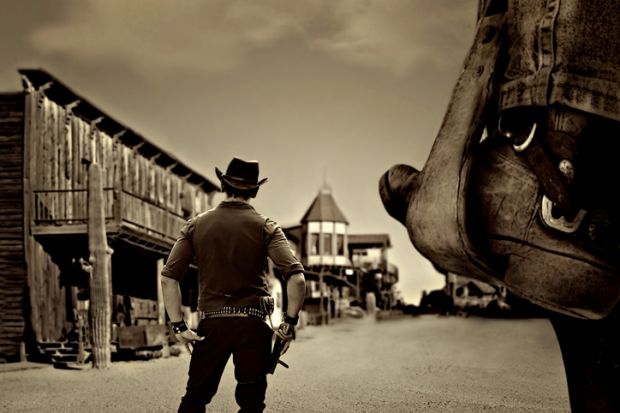 A cowboy enters a Wild West town 