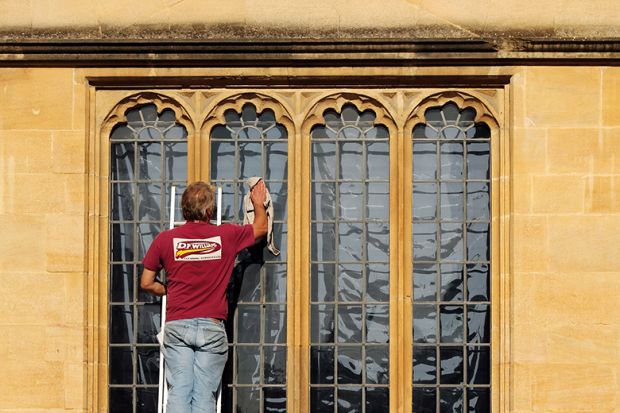 Man washing window