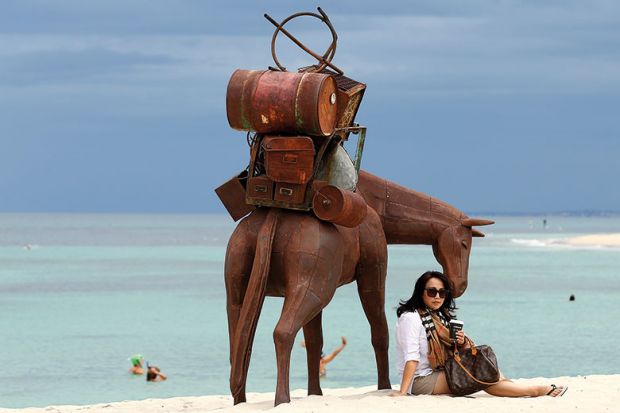woman and horse on beach