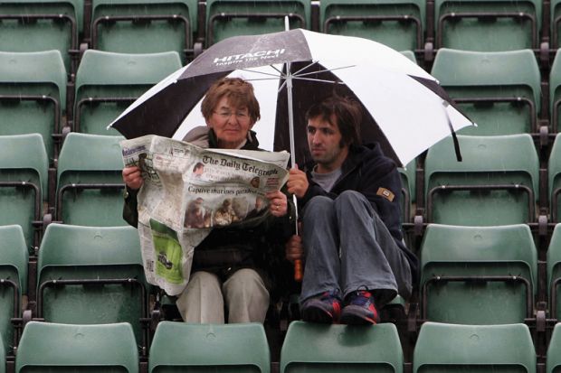 Woman and man read paper in rain