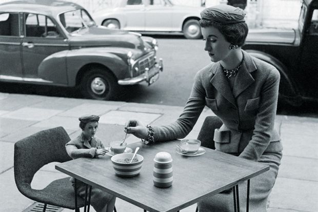 Woman sitting at a cafe with her miniature