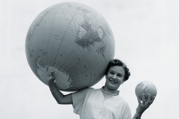 Woman holding large and small globes