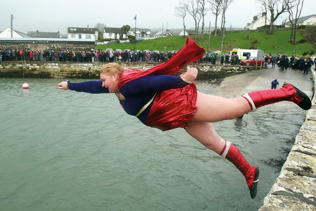 woman in superhero costume jumps into harbour