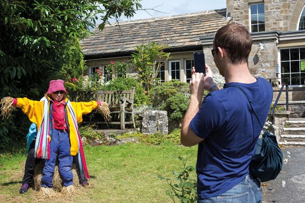 Woman pretends to be a scarecrow