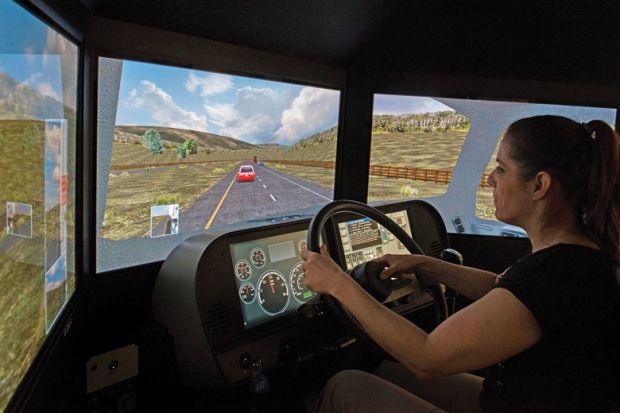 Woman using simulator to drive