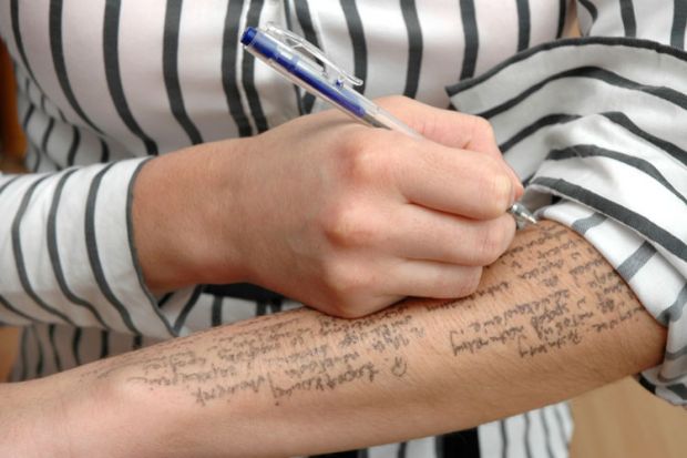 Exam cheating, woman writing notes on arm