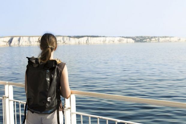 Woman looking out to white cliffs of Dover