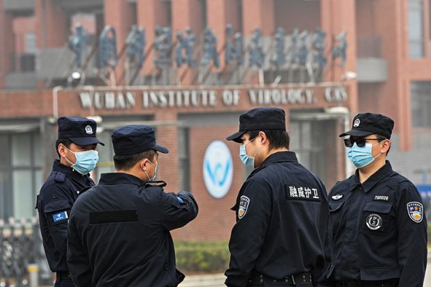 Security personnel stand guard outside the Wuhan Institute of Virology as members of the World Health Organization team investigating the origins of Covid-19 visit the institute